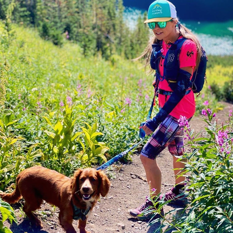 woman hiking with dog rocky mountains