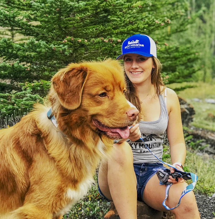 dog and girl camping in the Rocky Mountains