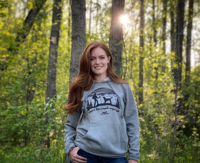 female in woods wearing RMD hoodie